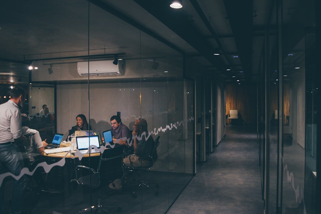 Diverse team collaborating on laptops in an office